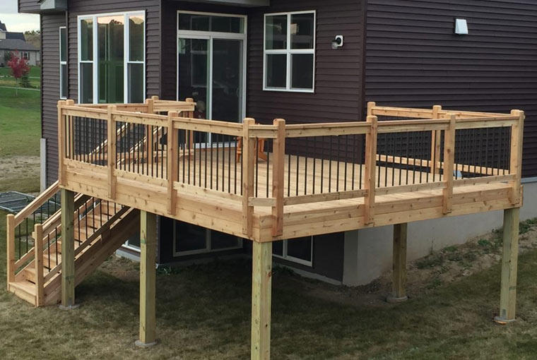 A fully cedar deck on a contemporary two-story home located in Minnetrista, MN